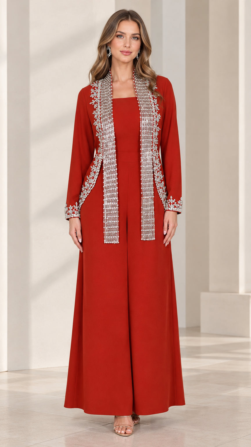 Front view of woman wearing elegant red wide-leg jumpsuit with rhinestone-embellished jacket