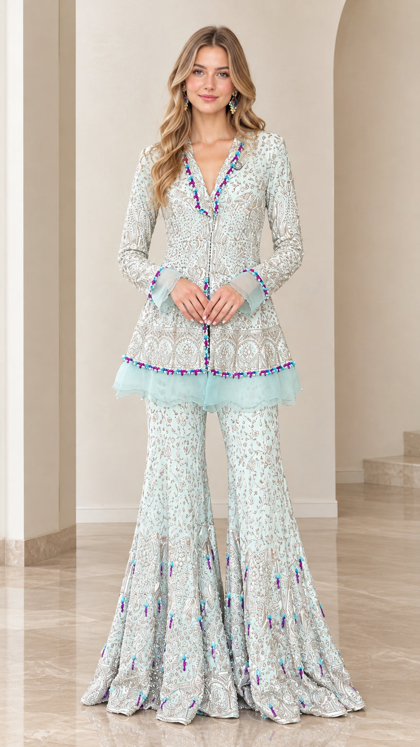 Front view of model wearing Ice Blue embroidered peplum tunic and flared gharara pants set