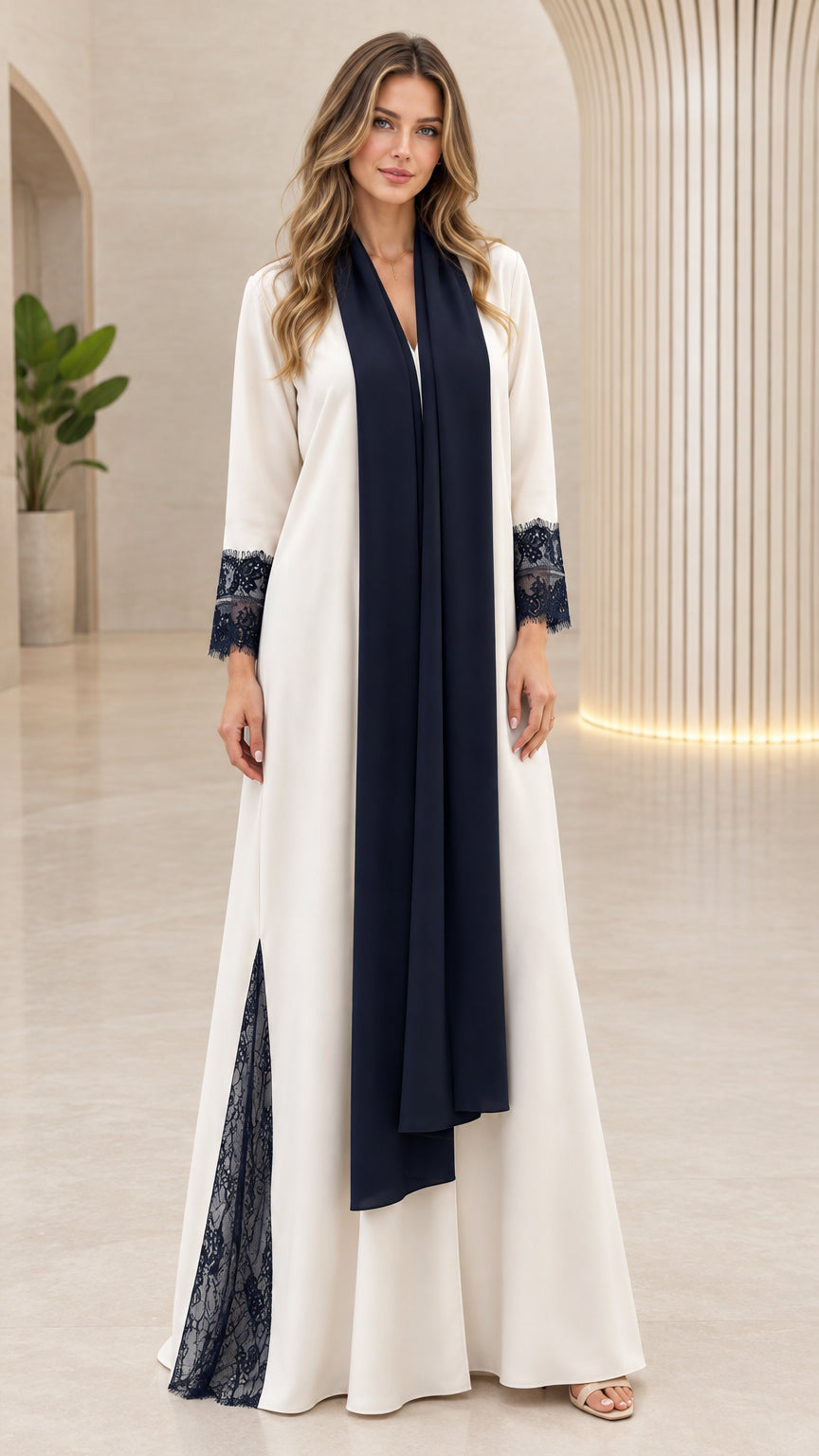 Front full-length view of woman wearing cream modest abaya dress with dark scarf and lace cuffs