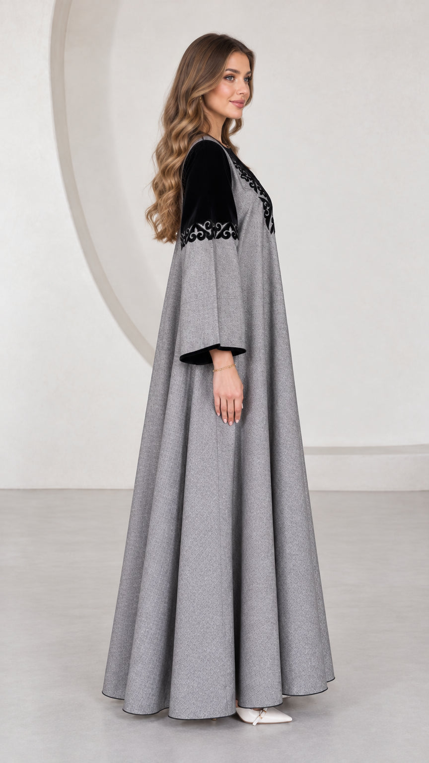 Side angle view of grey embroidered flowy A-line maxi dress