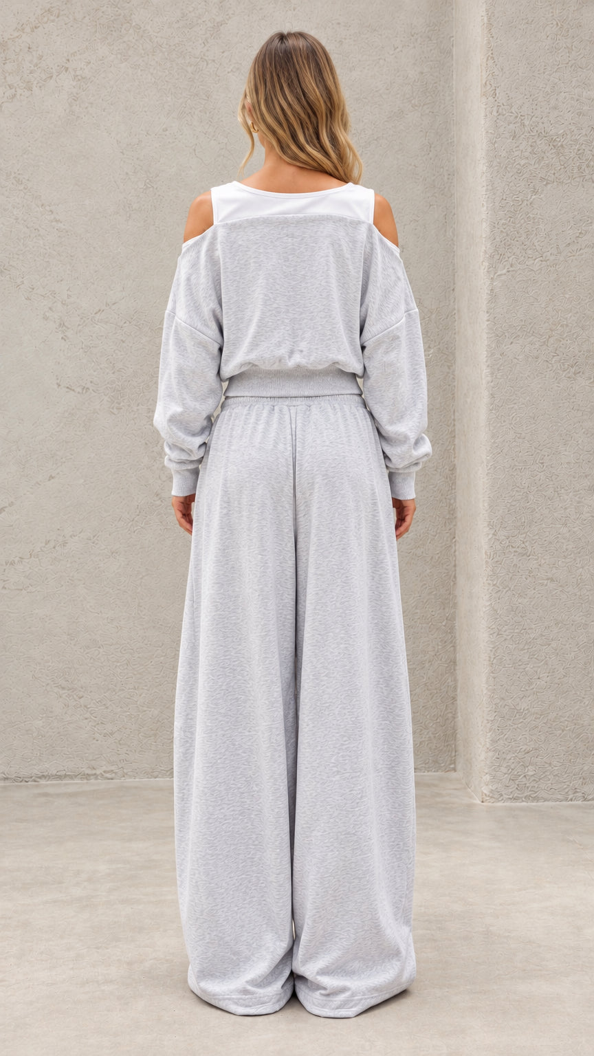 Back full-length view of model wearing heather grey cut out cropped lounge set