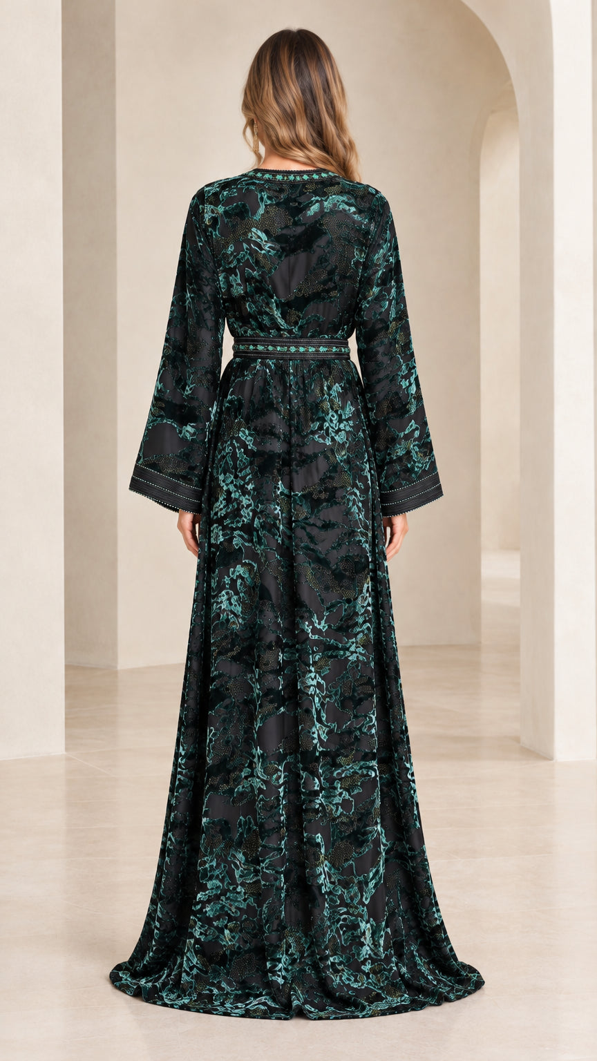 Back view of woman wearing emerald green floor-length velvet kaftan dress