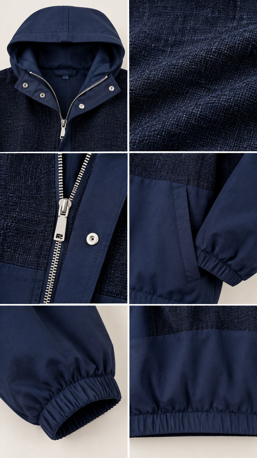 Detailed view of navy blue tracksuit jacket featuring hood, texture, zipper, and elastic cuffs