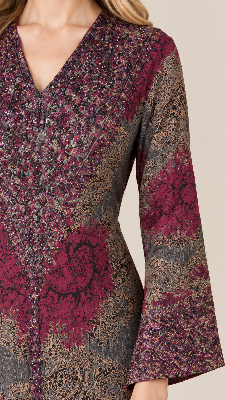 Close-up detail of embellished V-neckline and bell cuff pattern on burgundy dress