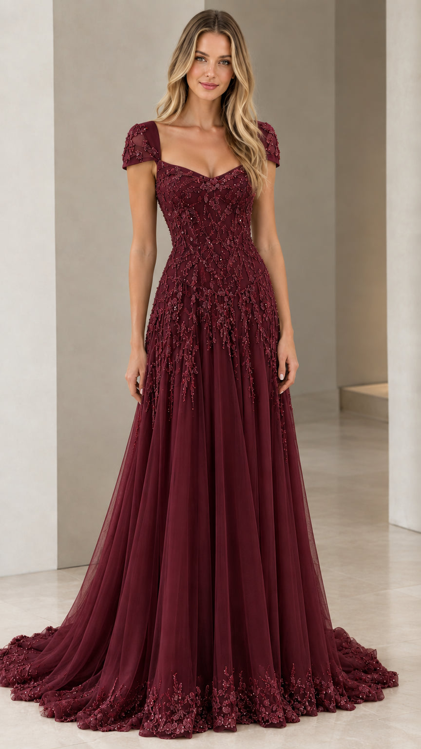 Front view of model in Burgundy beaded floor-length tulle formal gown