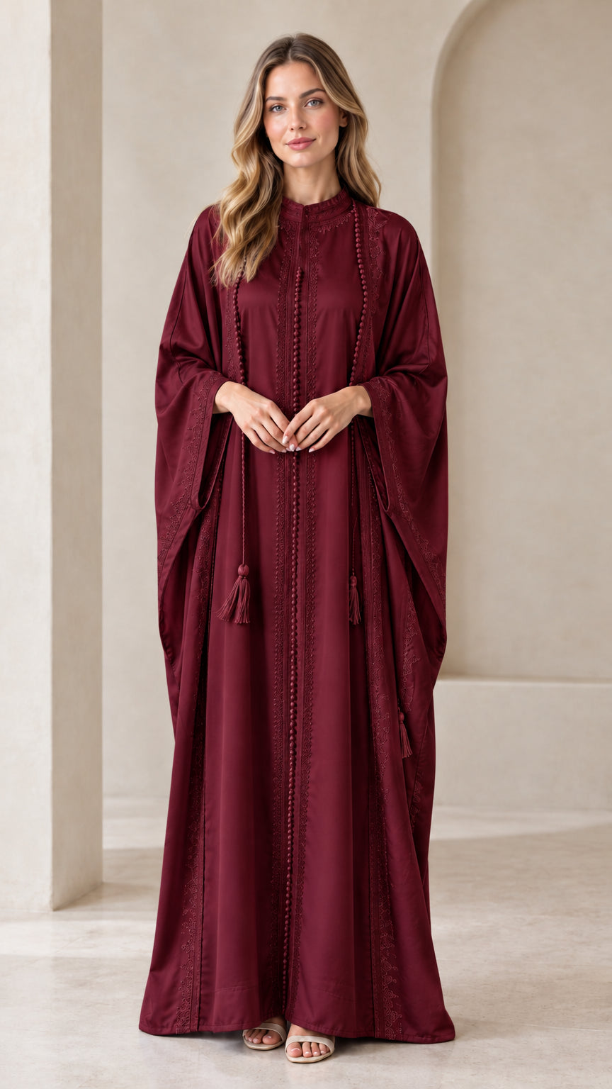 Front view of woman wearing Burgundy wine red embroidered batwing kaftan maxi dress with tassels