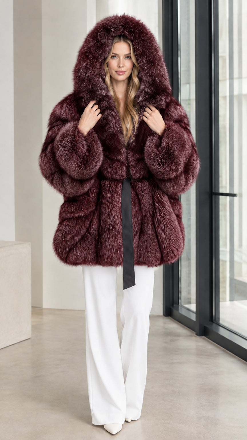 Deep burgundy wine hooded belted faux fur coat worn with white trousers