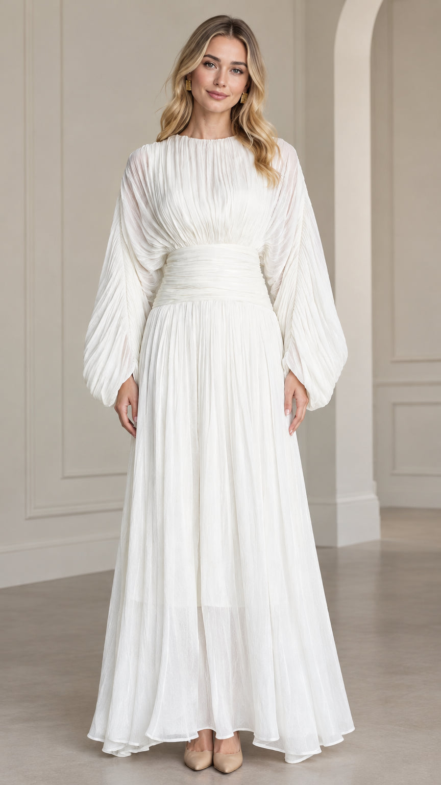 Front full-length view of woman wearing white pleated long sleeve maxi dress