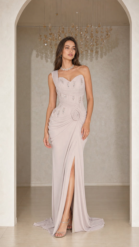 Front view of woman wearing silver grey one-shoulder beaded evening gown with slit