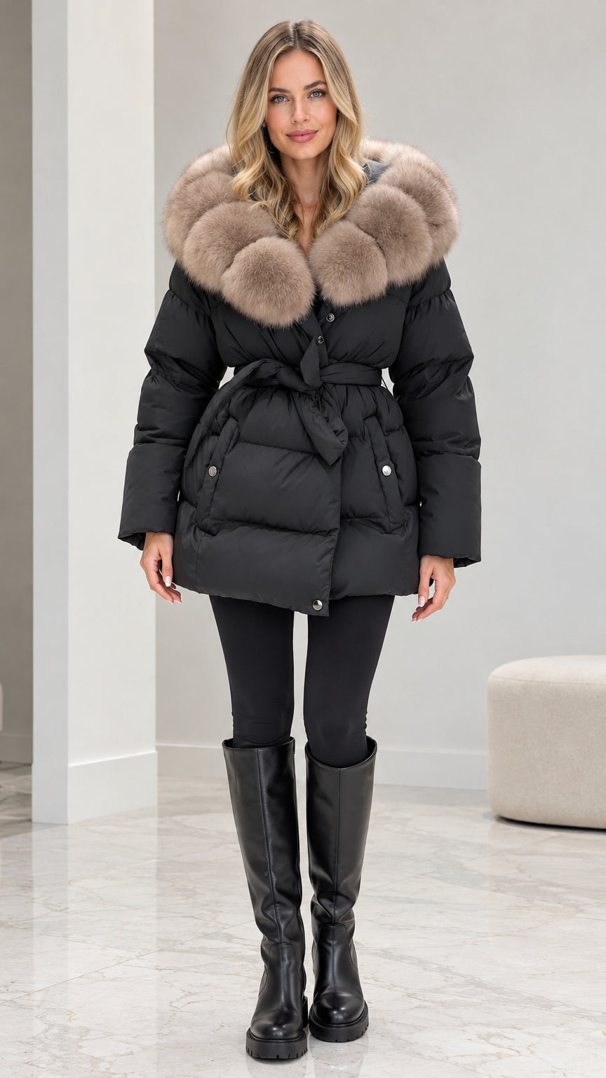 Front view of model wearing black belted puffer coat with plush faux fur collar