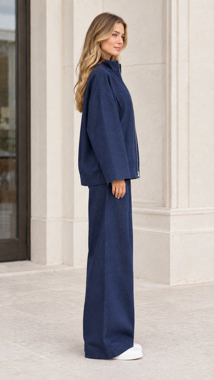 Navy blue two-piece zip jacket and wide-leg trouser set side profile