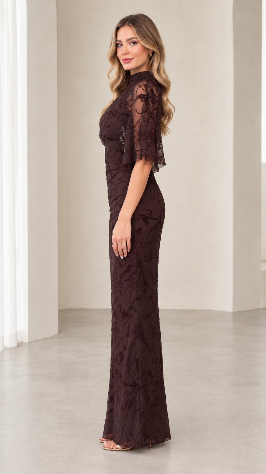 Side profile of model wearing Chocolate Brown formal beaded evening gown