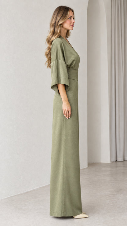 Side profile view of Sage Green wide leg jumpsuit showing drape and silhouette
