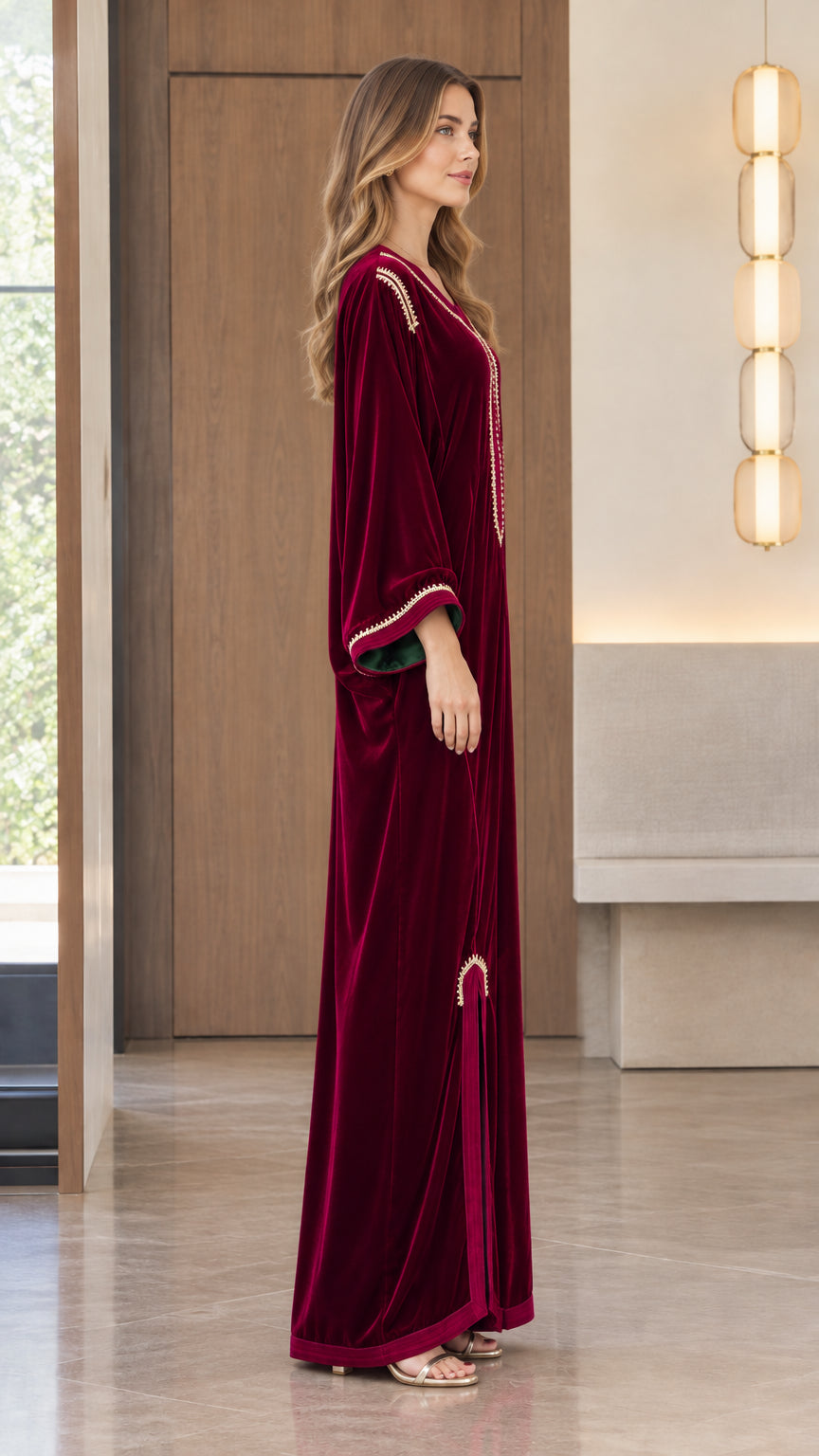 Side profile view of model wearing the Burgundy embroidered velvet maxi dress
