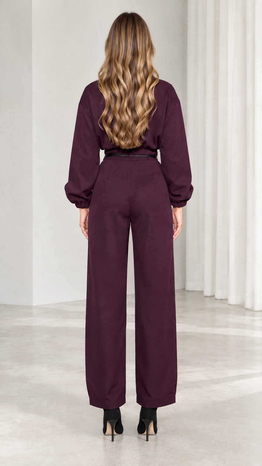 Back view of model in burgundy long sleeve utility jumpsuit