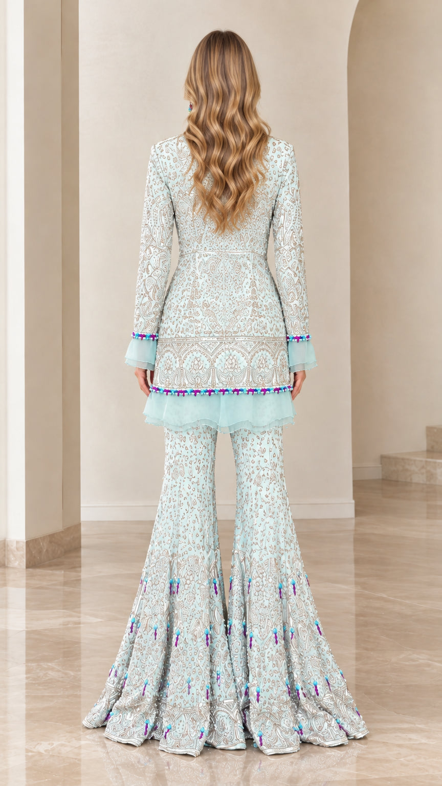 Back view of model wearing Ice Blue embroidered peplum tunic and wide-leg trousers