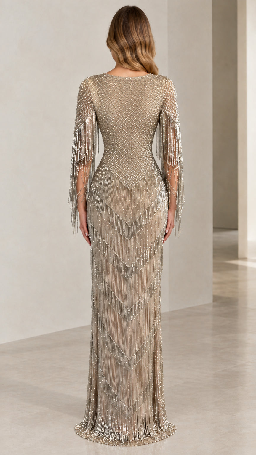 Back view of Champagne beaded fringe evening gown with fitted waist