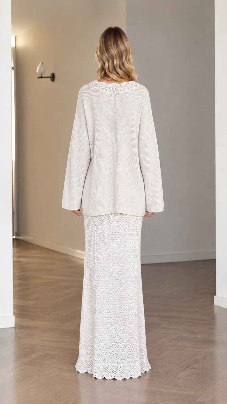 Back view of model wearing cream knit sweater and crochet maxi skirt