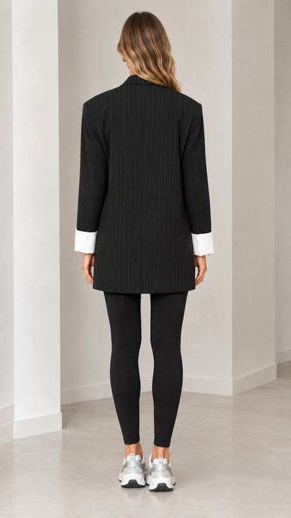 Back full-length view of tailored black pinstripe blazer