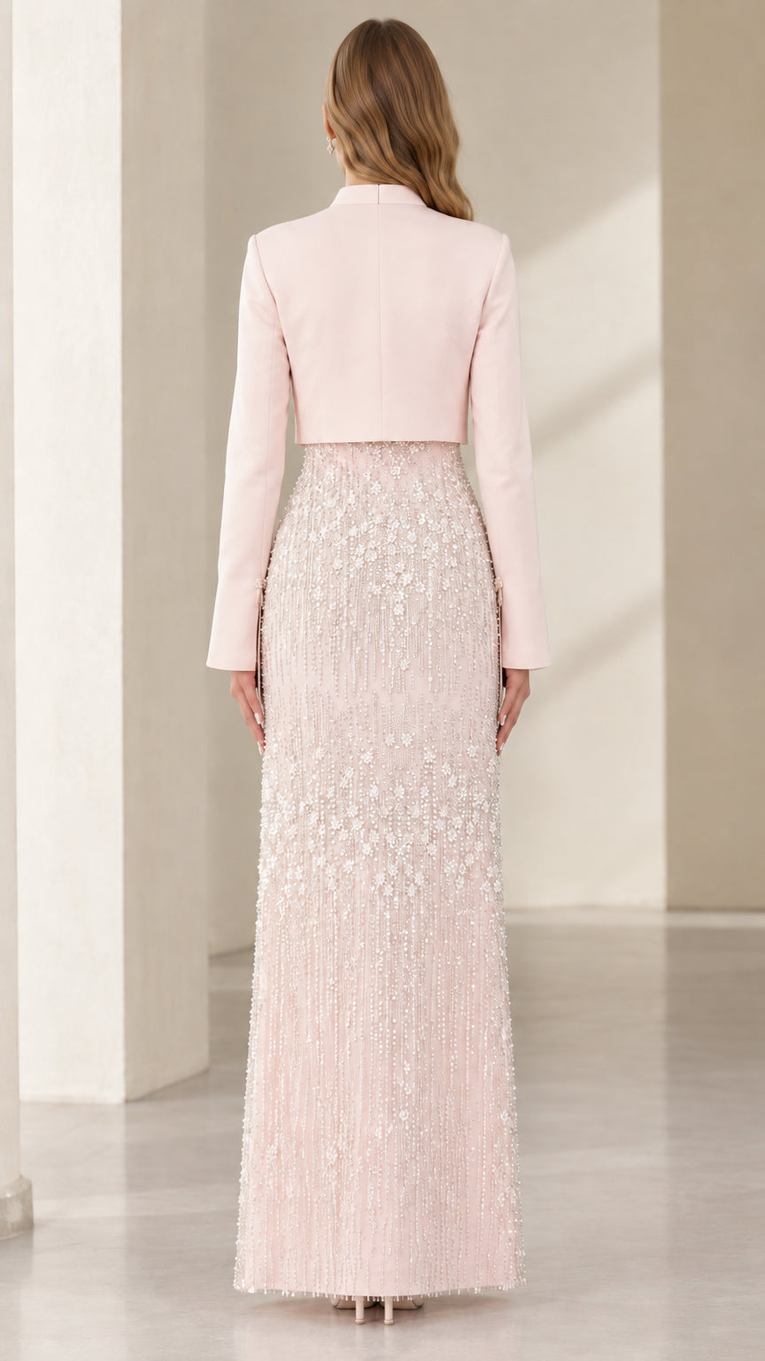 Back view of the Blush Pink tailored cropped jacket and floor-length embellished skirt