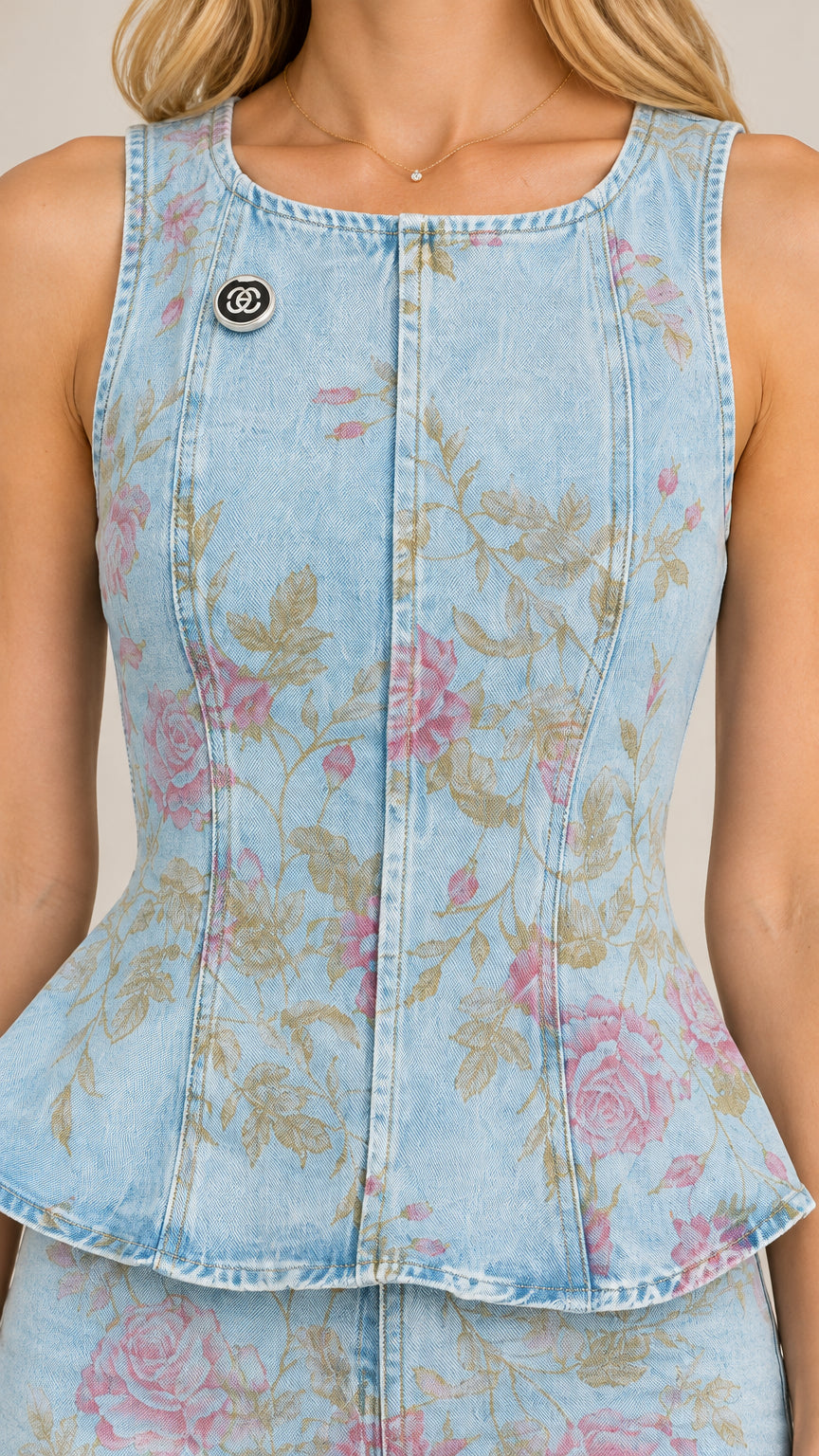 Close-up detail of Light Blue floral denim sleeveless peplum top with seam lines