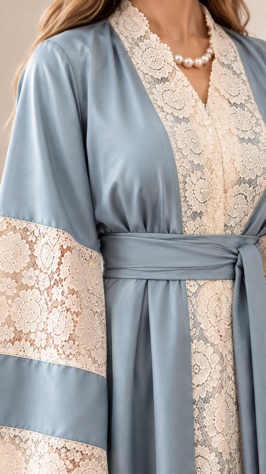 Close-up detail of cream floral lace collar, bodice panel, and sash belt on Dusty Blue abaya