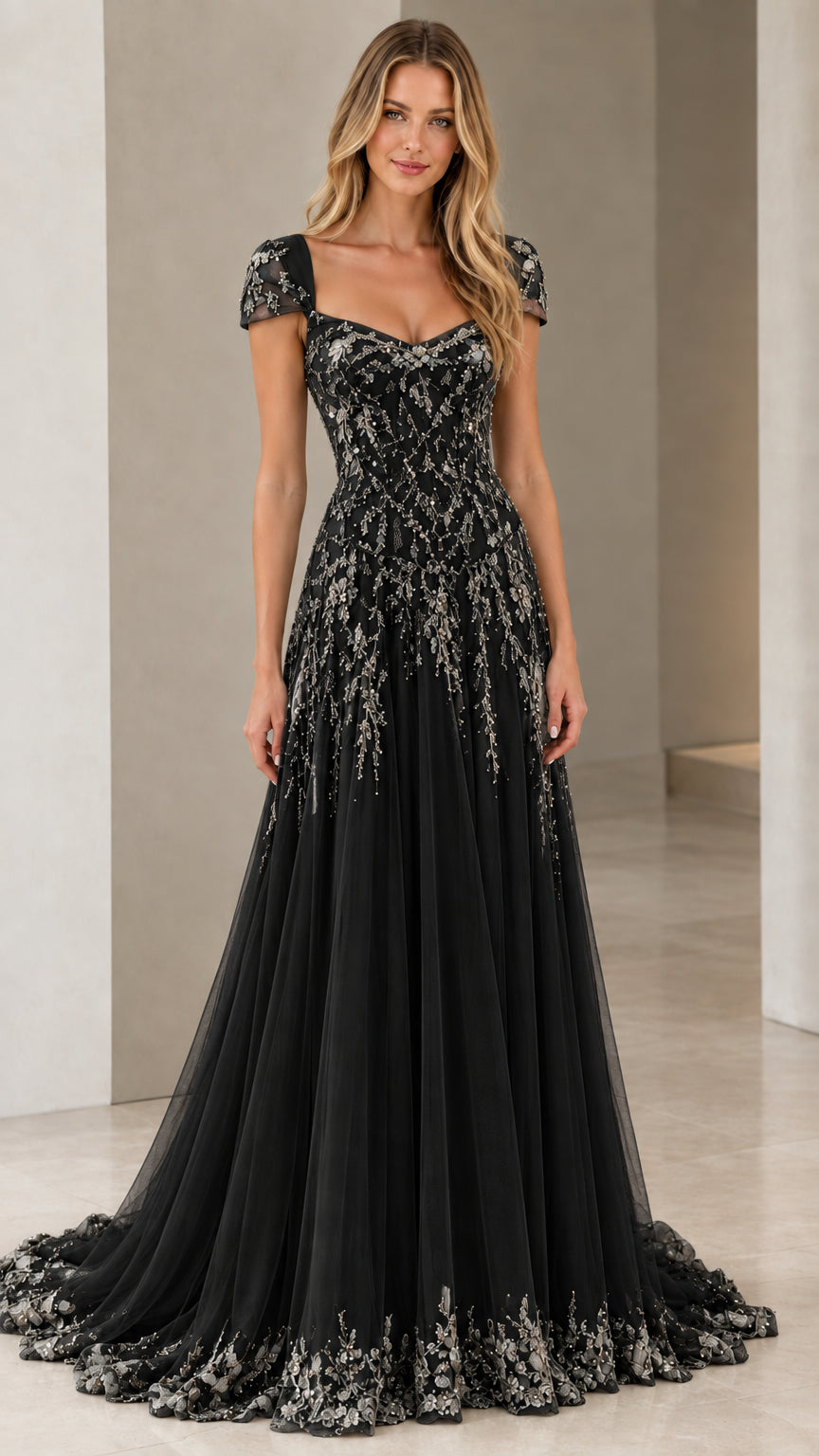 Front view of model in Black beaded cap sleeve A-line formal gown