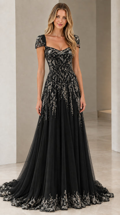 Front view of model in Black beaded cap sleeve A-line formal gown