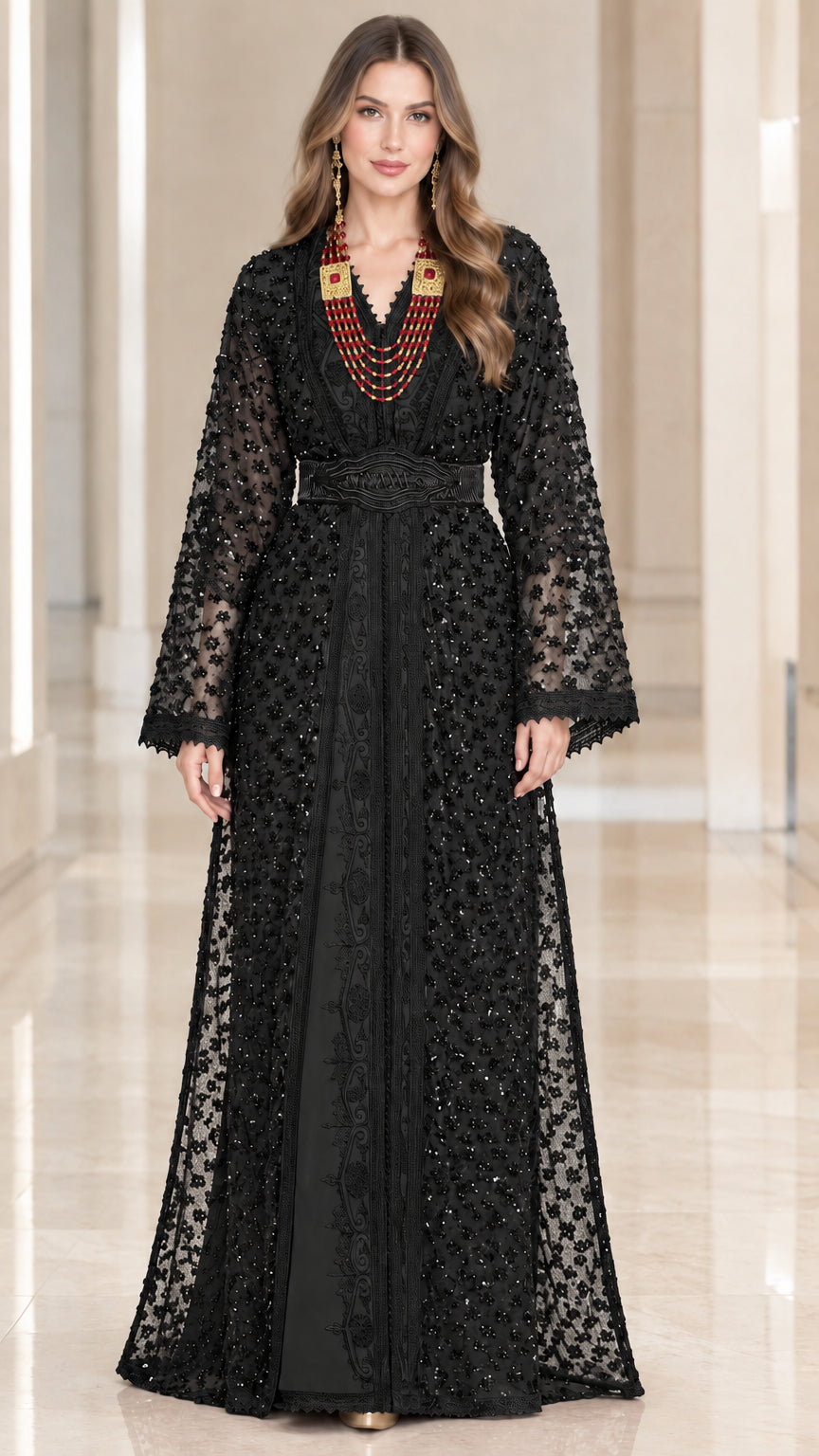 Full-length front view of woman wearing black embroidered beaded kaftan maxi dress with belt
