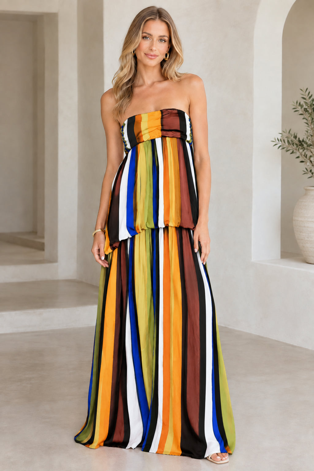 Model wearing black multicolor strapless striped maxi dress