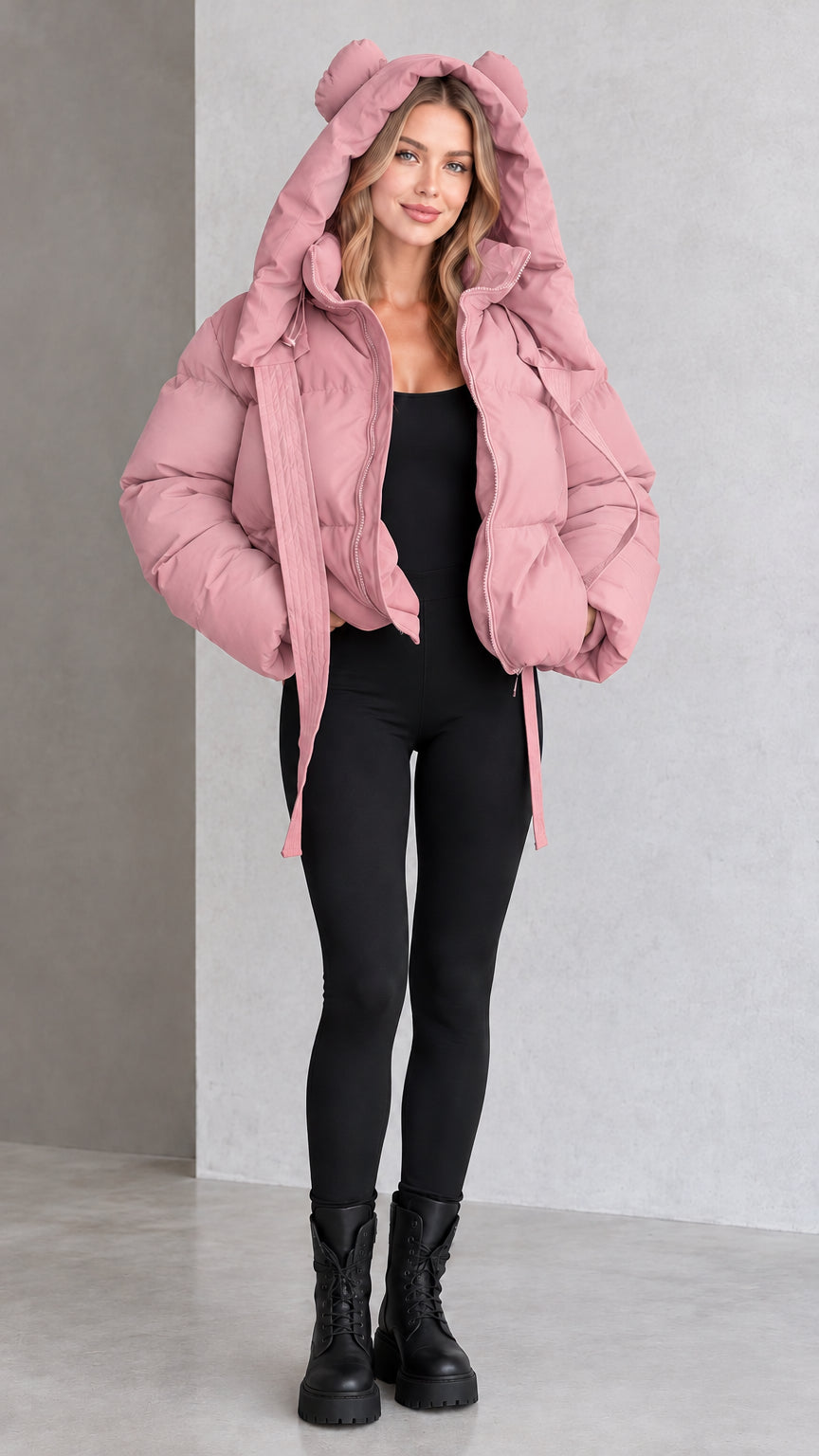 Model wearing dusty pink bear ear hooded cropped puffer jacket