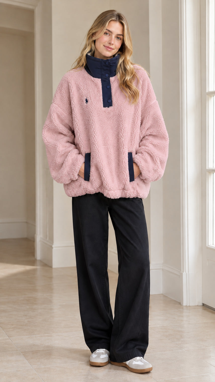 Full-length view of woman wearing Pink sherpa fleece snap-neck pullover with black trousers