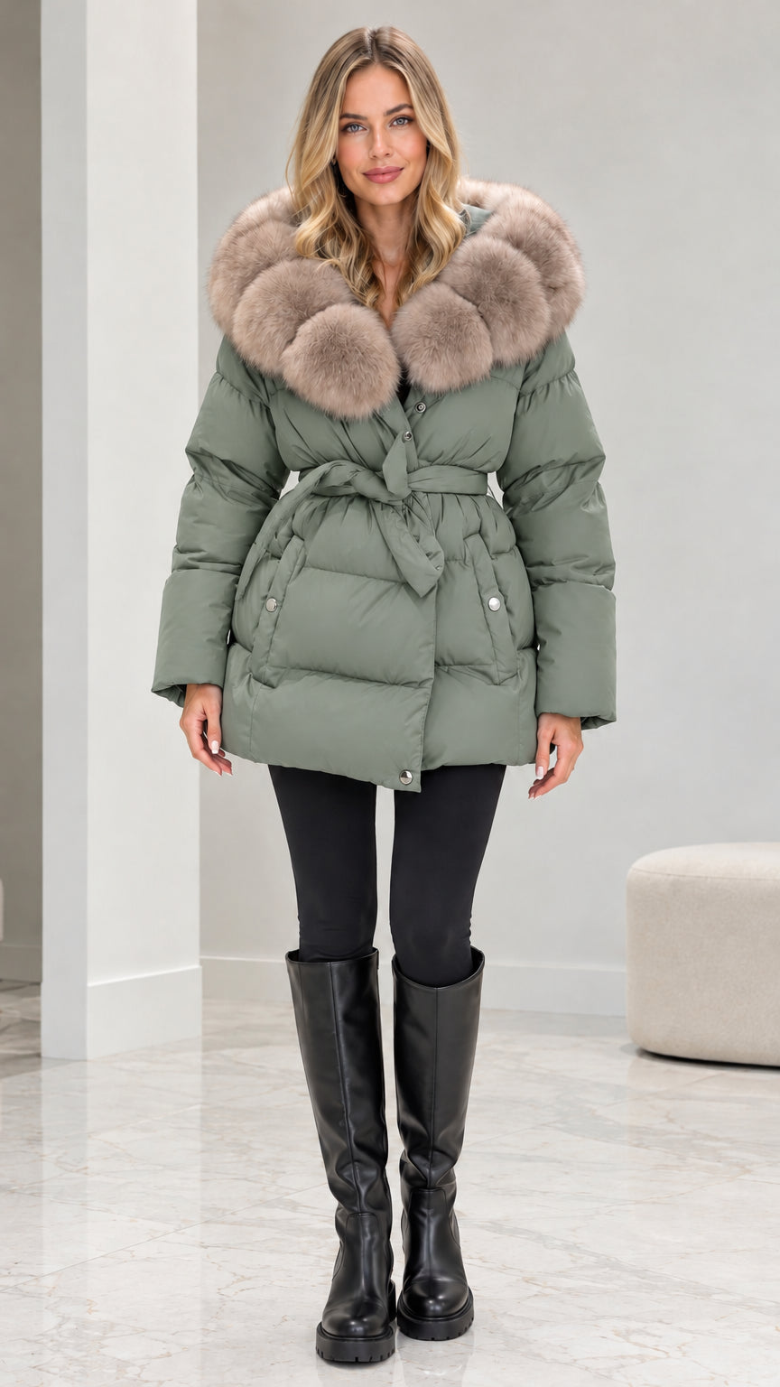 Front view of model wearing sage green belted quilted puffer coat