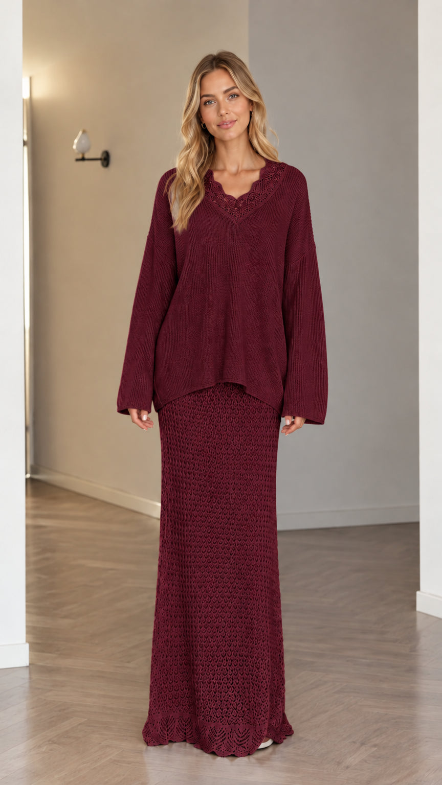 Model wearing burgundy two-piece knit sweater and maxi skirt set