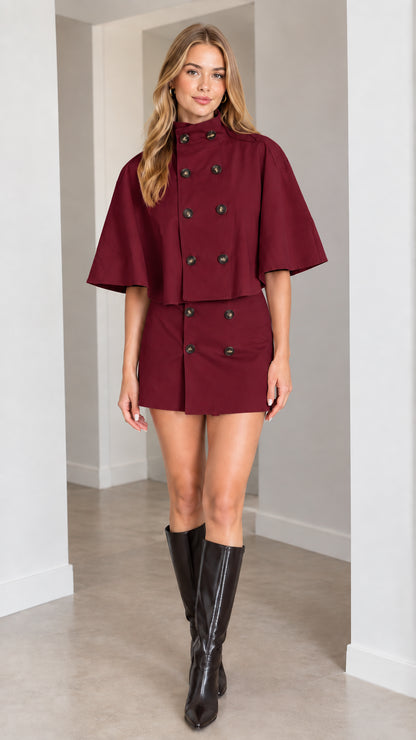 Model wearing burgundy wine red cape jacket and tailored mini skirt set