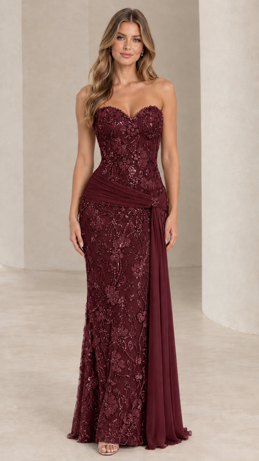 Front view of burgundy red strapless beaded evening dress with sash