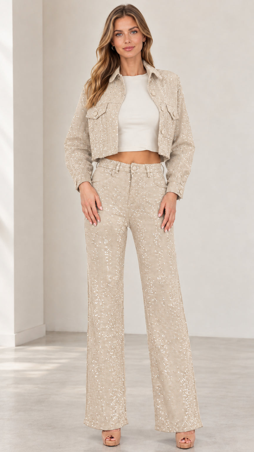Front view of woman wearing champagne beige sparkle cropped jacket and wide-leg trousers set